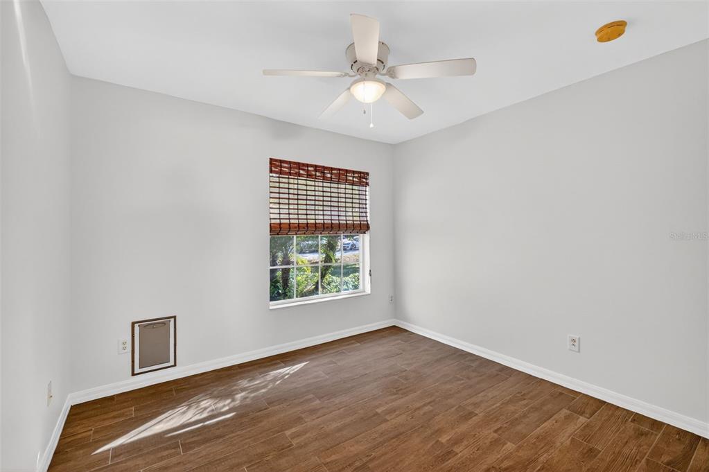 2113 Wolf Ridge Lane Mount Dora, FL 32757 - Photo 32 of 49 an empty room with wooden floor and windows