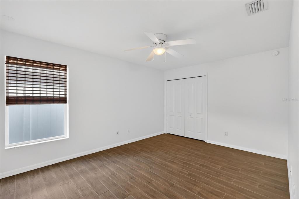 2113 Wolf Ridge Lane Mount Dora, FL 32757 - Photo 35 of 49 a view of an empty room with wooden floor and a window