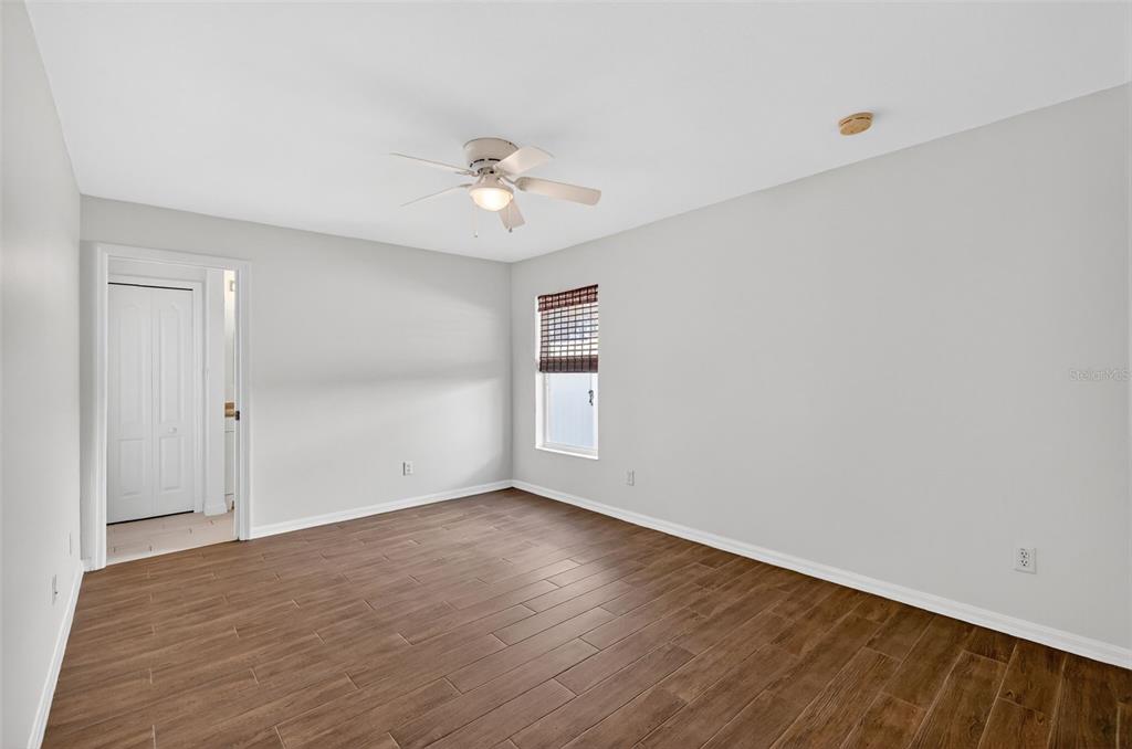 2113 Wolf Ridge Lane Mount Dora, FL 32757 - Photo 37 of 49 a view of empty room with wooden floor and fan