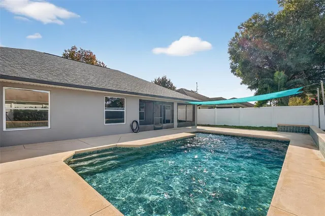 a backyard of a house with table and chairs