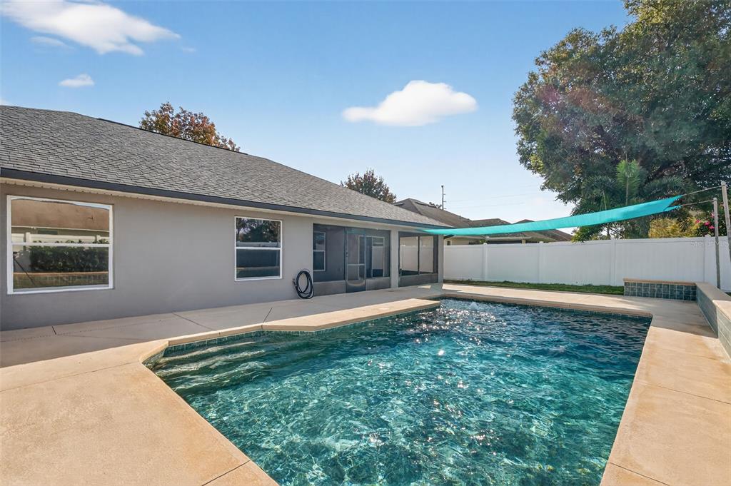 2113 Wolf Ridge Lane Mount Dora, FL 32757 - Photo 43 of 49 a backyard of a house with table and chairs