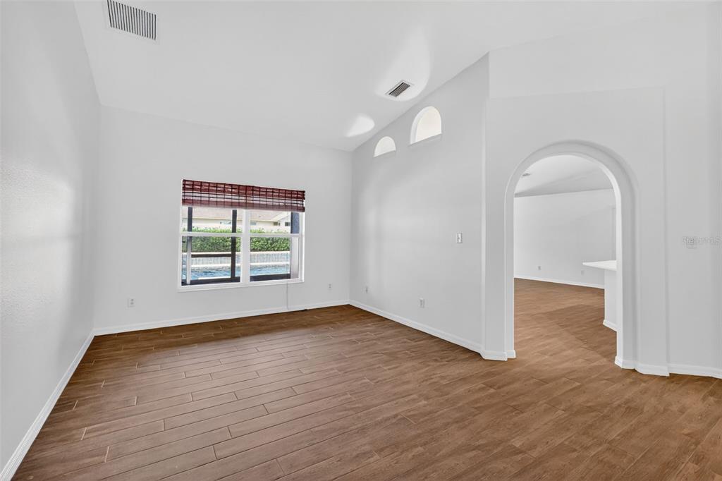 2113 Wolf Ridge Lane Mount Dora, FL 32757 - Photo 8 of 49 an empty room with wooden floor and windows