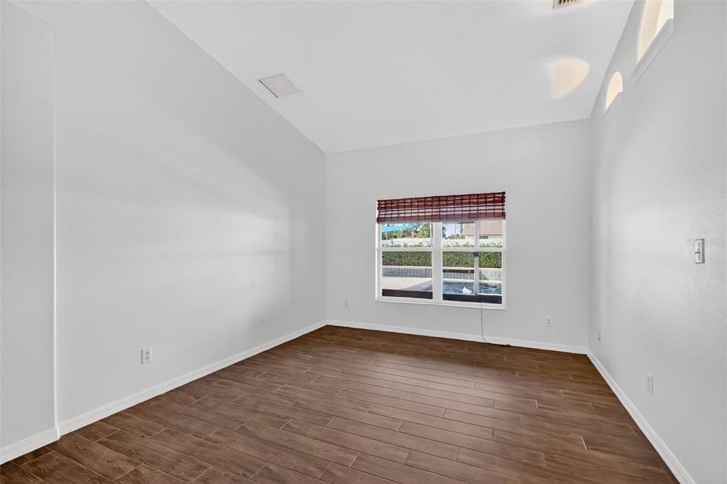 2113 Wolf Ridge Lane Mount Dora, FL 32757 - Photo 9 of 49 wooden floor in an empty room with a window