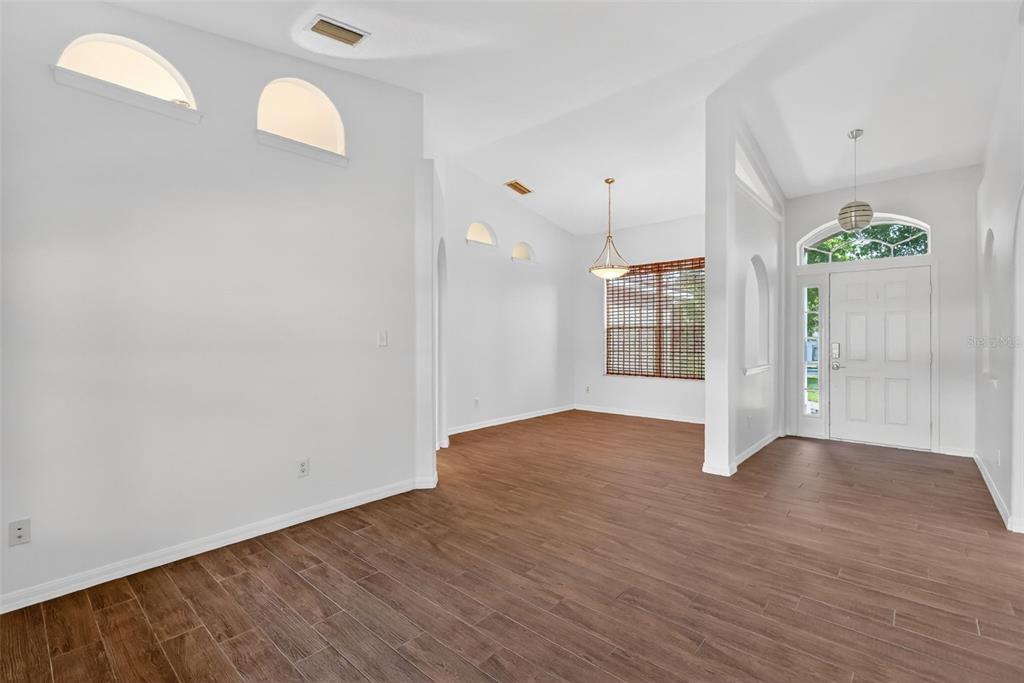 2113 Wolf Ridge Lane Mount Dora, FL 32757 - Photo 10 of 49 an empty room with wooden floor and windows