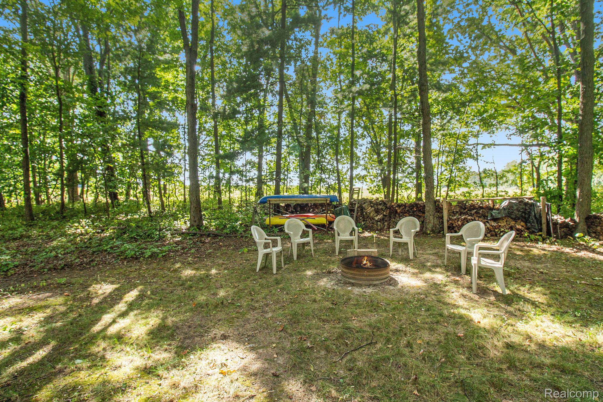 13610 Holtforth Road Fenton, MI 48430 - Photo 24 of 31 Firepit in Side Yard is Perfect for Outdoor Fun