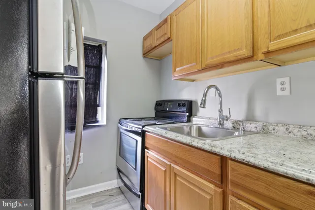 a kitchen with stainless steel appliances granite countertop a sink and cabinets