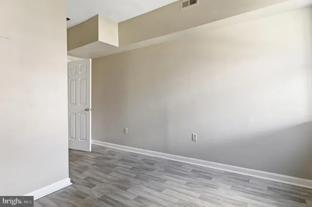 a view of a room with wooden floor