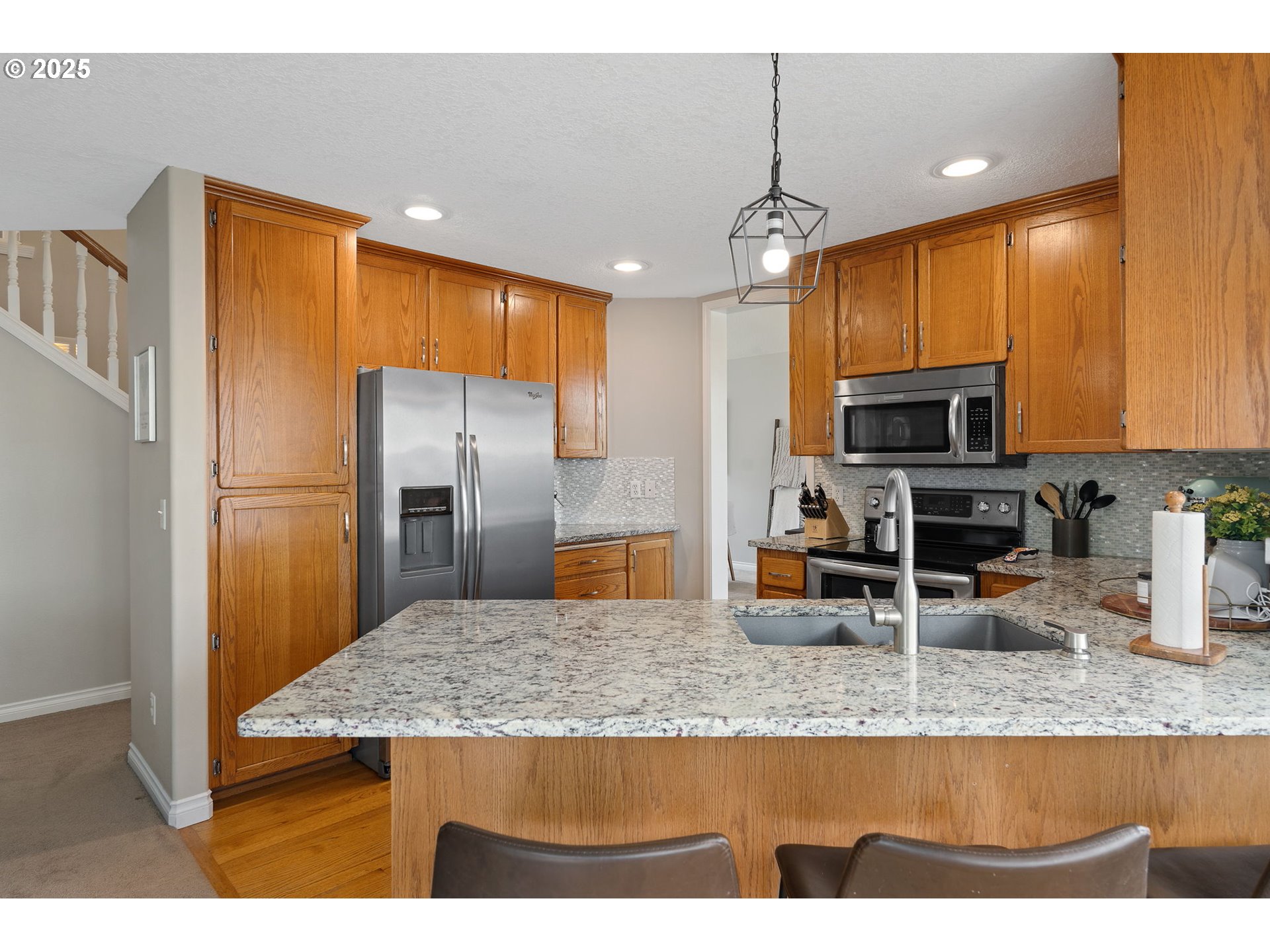 2326 Southeast Robin Lane Gresham, OR 97080 - Photo 11 of 33 a kitchen with kitchen island a counter top space cabinets and stainless steel appliances