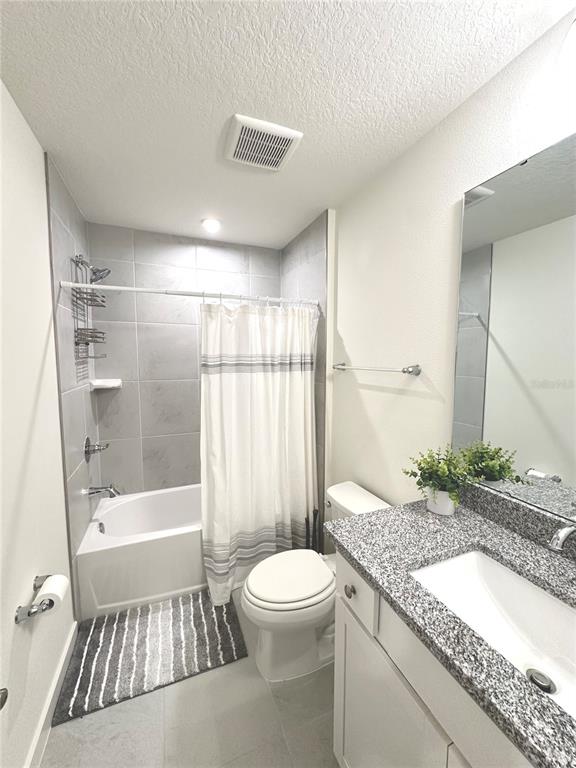 2023 Iorio Street St. Cloud, FL 34771 - Photo 4 of 4 a bathroom with a granite countertop sink toilet and shower