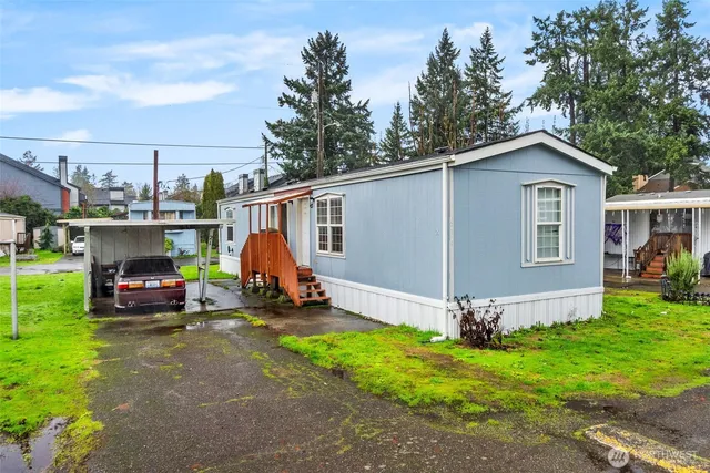 a view of a house with a yard and sitting area