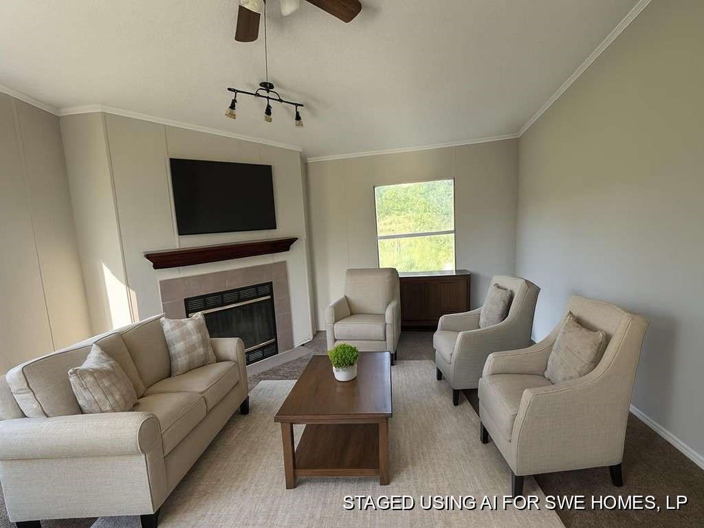 102 Bailey Street Van Alstyne, TX 75495 - Photo 3 of 14 a living room with furniture a fireplace and a flat screen tv