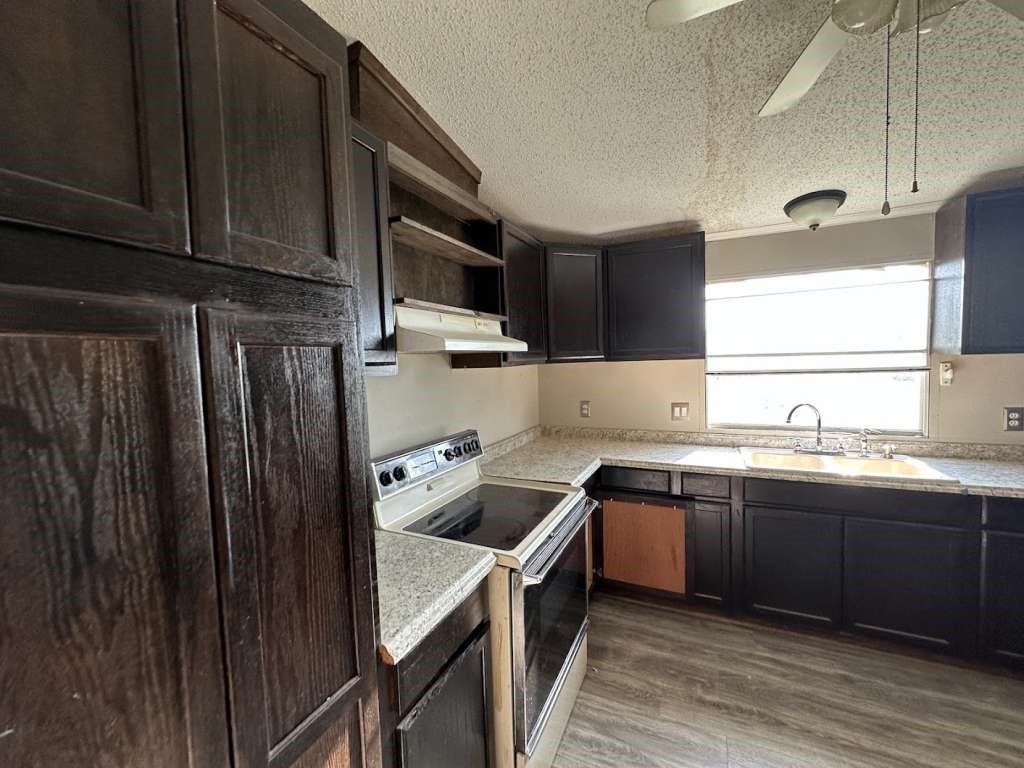 102 Bailey Street Van Alstyne, TX 75495 - Photo 5 of 14 a kitchen with a sink and cabinets