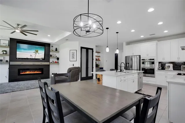 a kitchen with sink cabinets and dining table