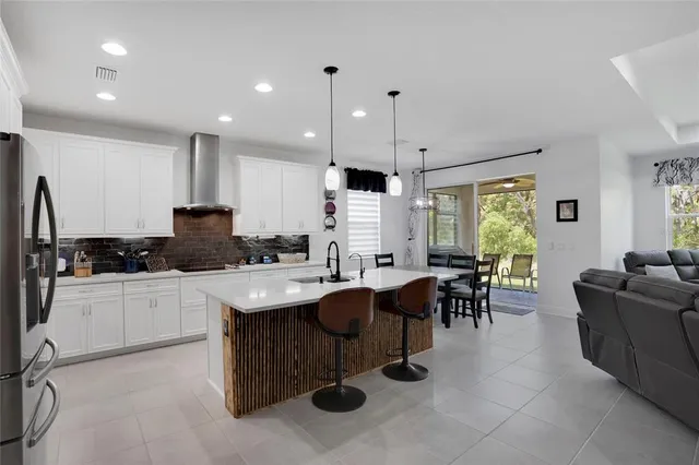 a kitchen with a dining table chairs sink and microwave