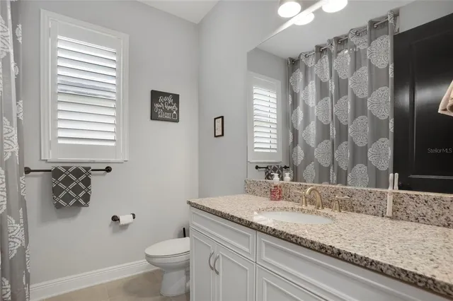 a bathroom with a shower and mirror