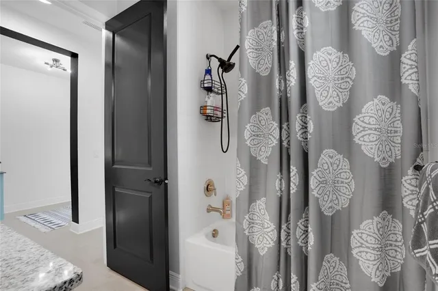 a bathroom with a granite countertop sink toilet and mirror