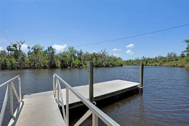 a view of a field with trees in the background