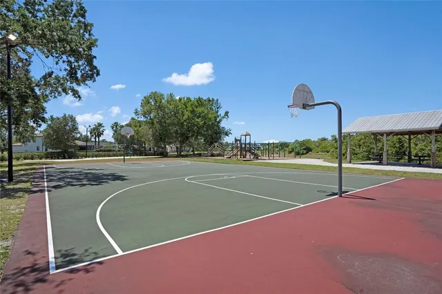 a park with slide trees and wooden fence