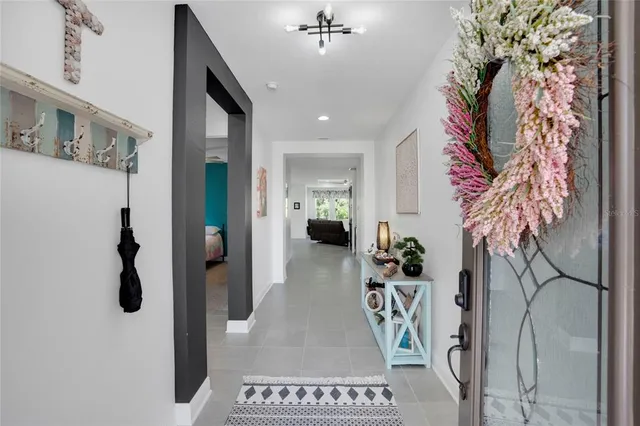 a view of a hallway and a livingroom with furniture