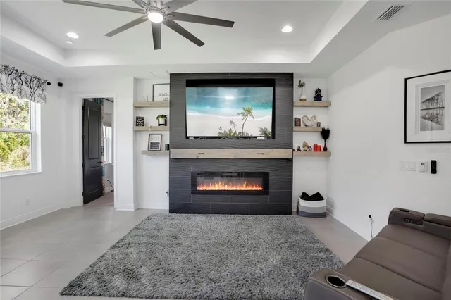 a living room with furniture a flat screen tv and a fireplace