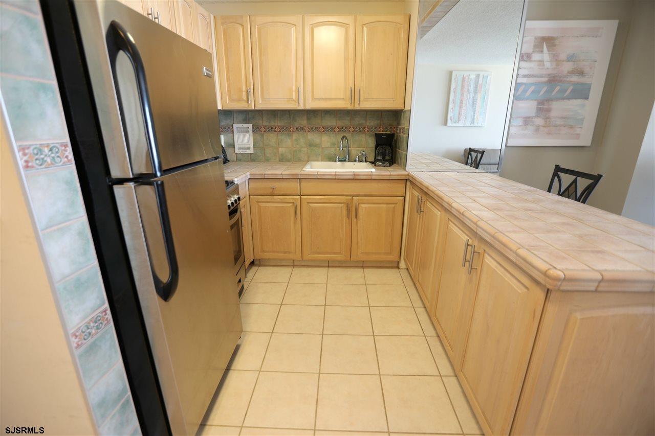 9400 Atlantic Avenue, Unit 709 Margate City, NJ 08402 - Photo 4 of 11 a utility room with cabinets washer and dryer