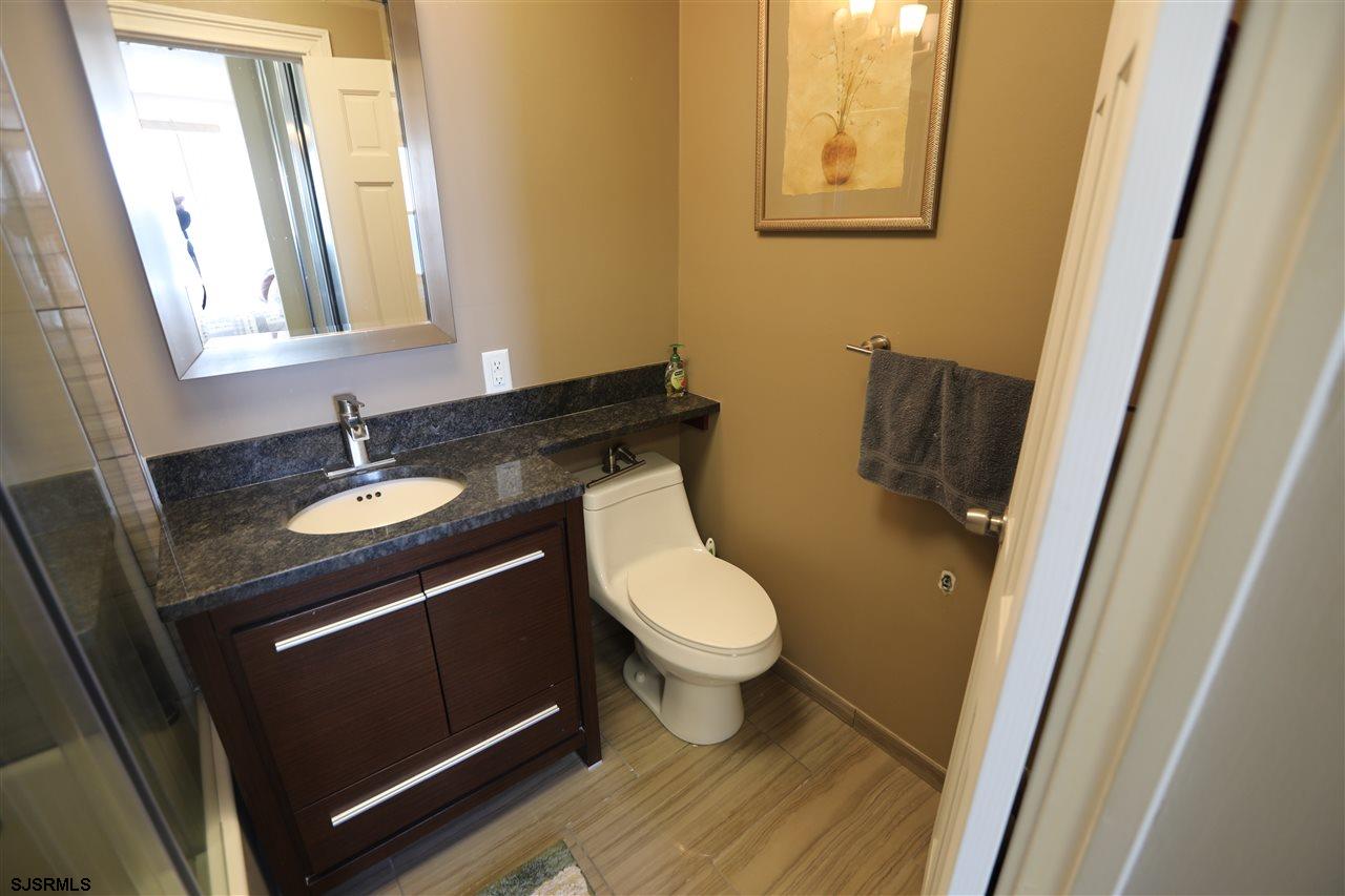 9400 Atlantic Avenue, Unit 709 Margate City, NJ 08402 - Photo 10 of 11 a bathroom with a sink and a mirror