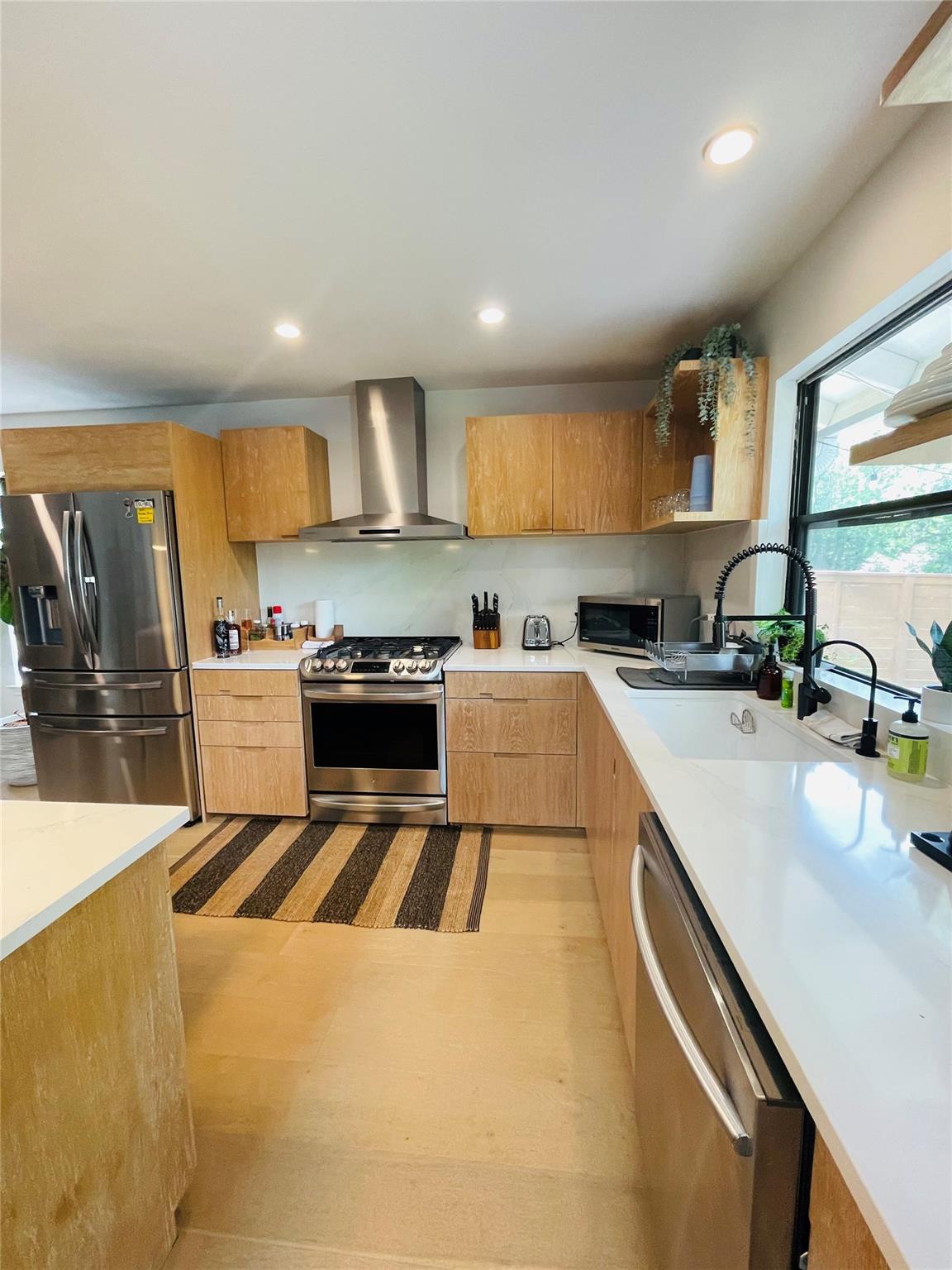 8418 Seminary Ridge Drive Austin, TX 78745 - Photo 8 of 19 a kitchen that has a sink and a stove in it