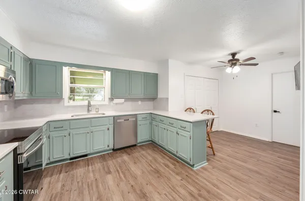 a kitchen with a sink stove and refrigerator