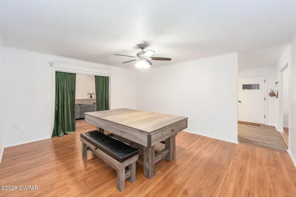 a room with a table and wooden floor