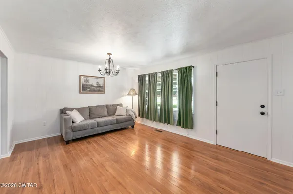 a living room with a couch and a chandelier