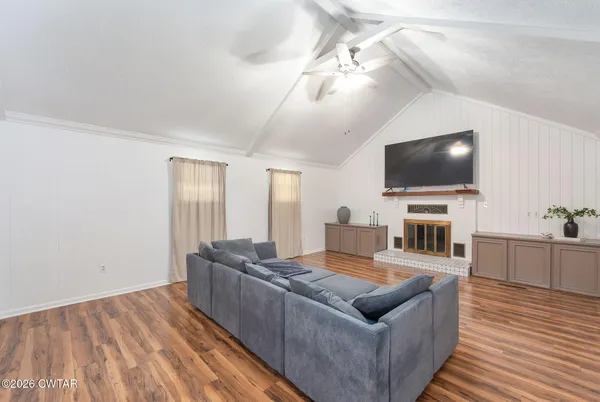 a living room with furniture and a wooden floor