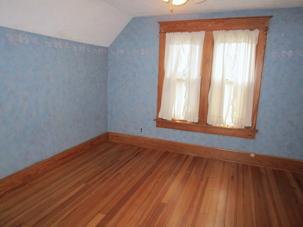 119 West Chestnut Street Compton, IL 61318 - Photo 15 of 27 a view of an empty room with wooden floor and a window