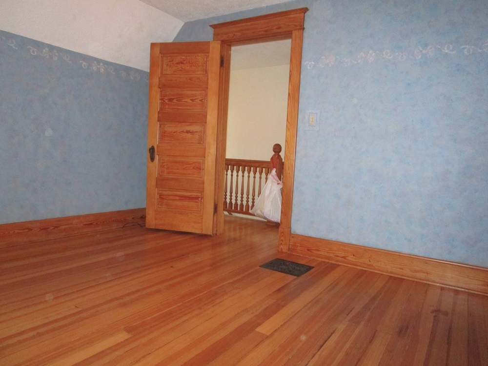 119 West Chestnut Street Compton, IL 61318 - Photo 16 of 27 a view of an empty room with wooden floor and a window