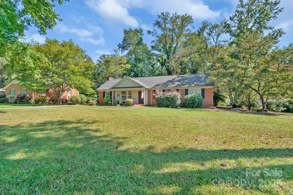 a front view of house with yard and green space