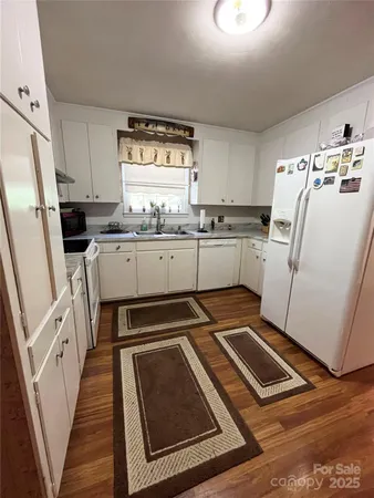 a kitchen with sink refrigerator and stove