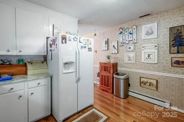 a kitchen with refrigerator and cabinets
