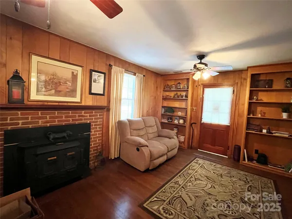 a living room with furniture cabinets and window