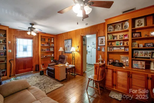 a living room with furniture fireplace and a large window