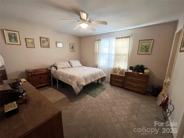 a bedroom with a large bed and a tv