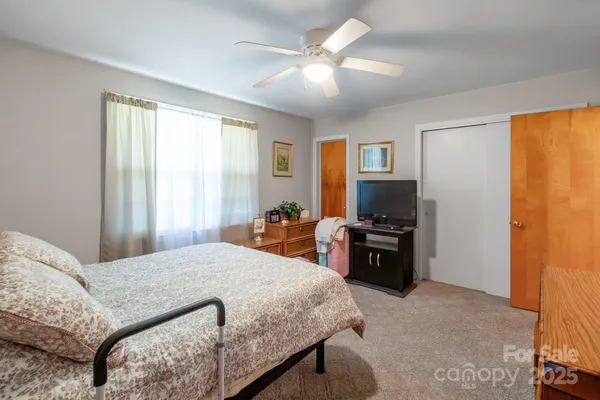 a bedroom with a bed and a television in it