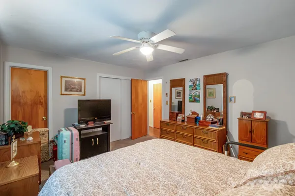 a bedroom with a bed and a chandelier