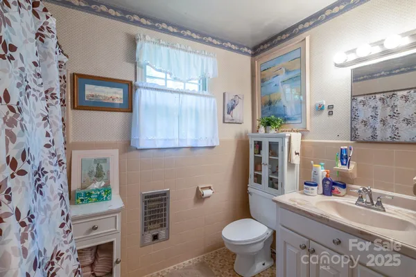 a bathroom with a sink toilet and a shower