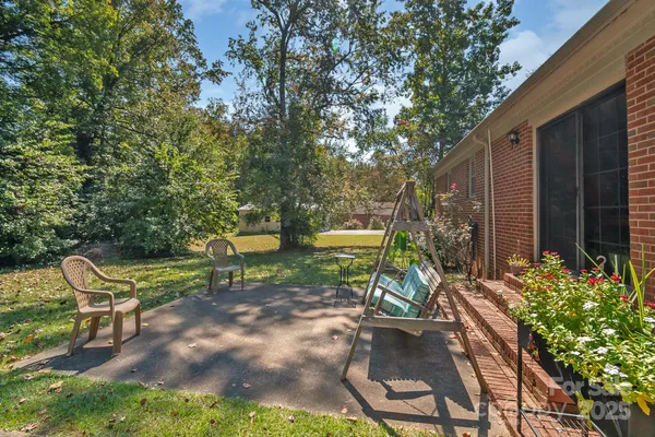 a front view of a house with garden and patio