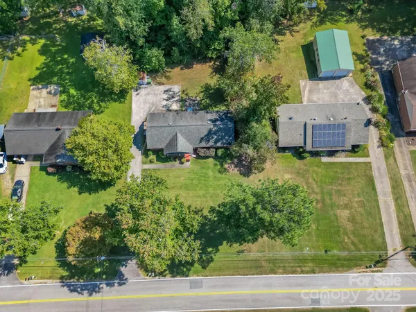 an aerial view of a house with garden space and street view