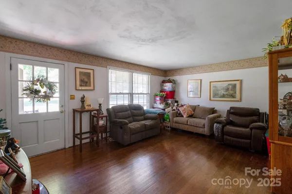 a living room with furniture window and wooden floor