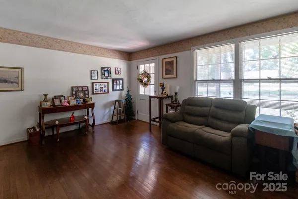 a living room with furniture and a wooden floor