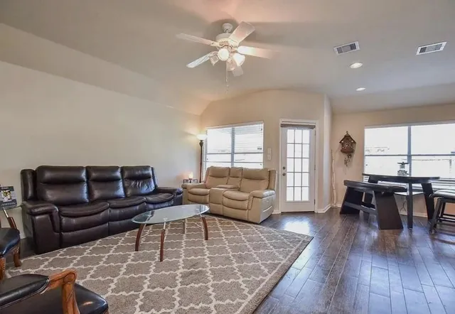 a kitchen with stainless steel appliances granite countertop table chairs sink and cabinets