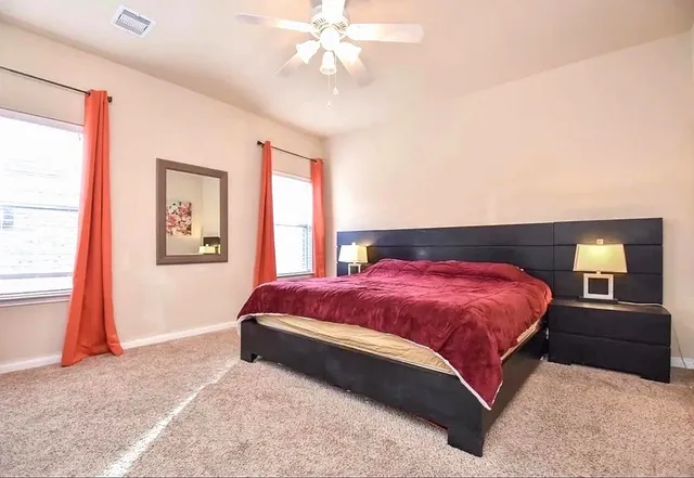 a bedroom with a bed and a window