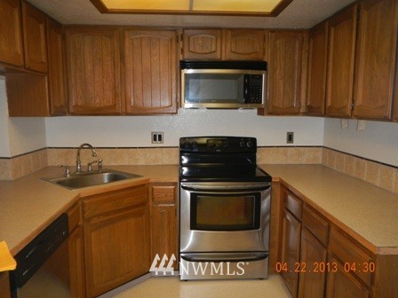 2517 Northeast 4th Street, Unit 524 Renton, WA 98056 - Photo 2 of 10 a kitchen with a stove microwave and sink