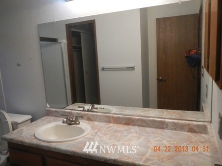 2517 Northeast 4th Street, Unit 524 Renton, WA 98056 - Photo 8 of 10 a bathroom with a sink and a mirror